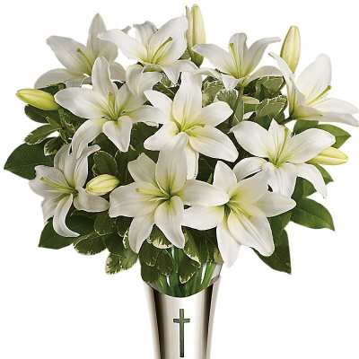 White lilies arranged in a silver vase with a cross emblem