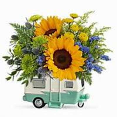 Sunflower bouquet arranged in a small camper-shaped container