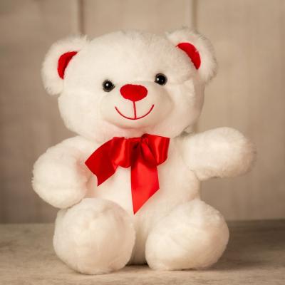 White teddy bear with a red bow and red nose