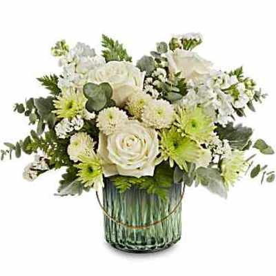 White floral arrangement in a green glass vase