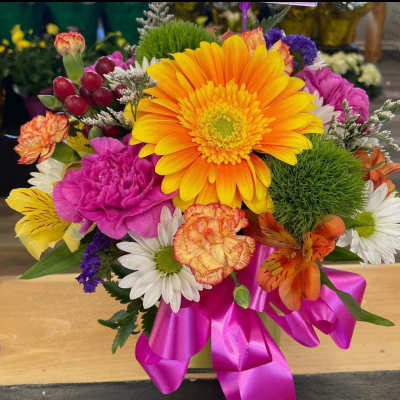 Bright mixed bouquet with a large orange gerbera daisy and pink carnations