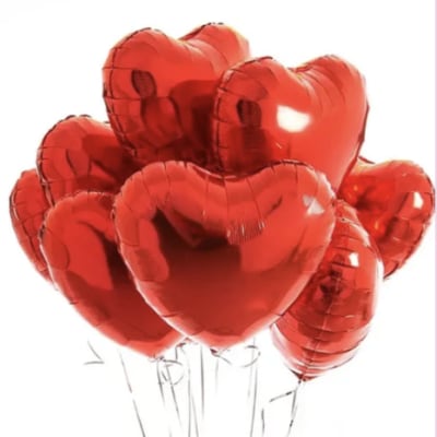 Cluster of red heart-shaped balloons on thin sticks