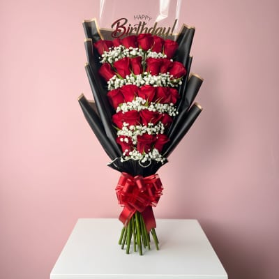 Bouquet of red roses with white baby's breath and a birthday topper