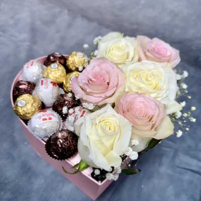 Pink heart-shaped box with roses and assorted chocolates