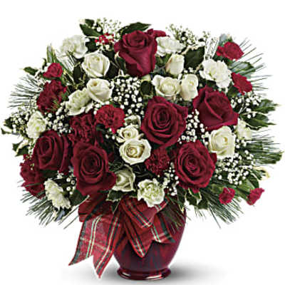 Bouquet of red and white roses in a red vase with plaid ribbon