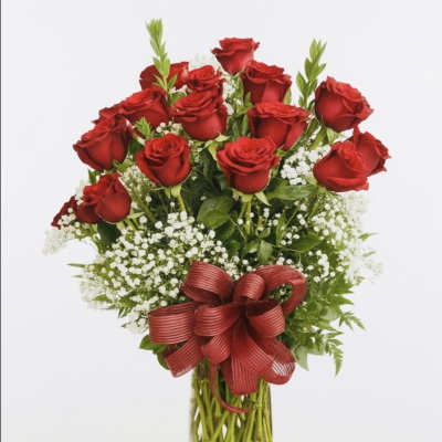 Bouquet of red roses with baby's breath in a clear glass vase and red ribbon