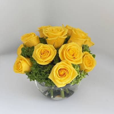 Yellow roses arranged in a clear glass vase