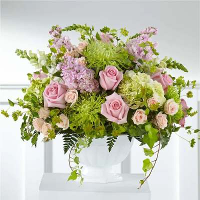 Pink roses and green chrysanthemums in a white vase