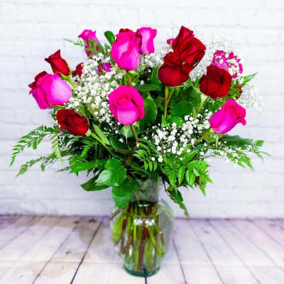 Bouquet of pink and red roses in a clear glass vase