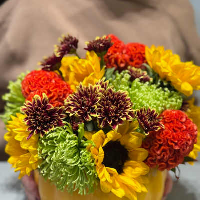 Mixed flowers arranged in a pumpkin-shaped container
