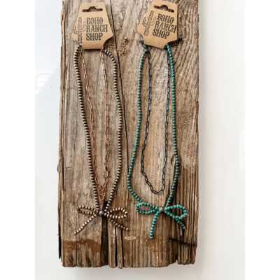 Two beaded necklaces on a rustic wooden board with cardboard tags