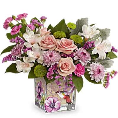 Pink and white mixed flower arrangement in a square glass vase