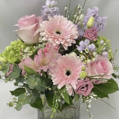 Pink and lavender mixed bouquet in a clear glass vase
