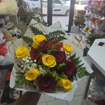 A dozen yellow and red roses