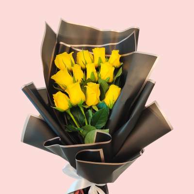 Bouquet of yellow roses wrapped in black paper
