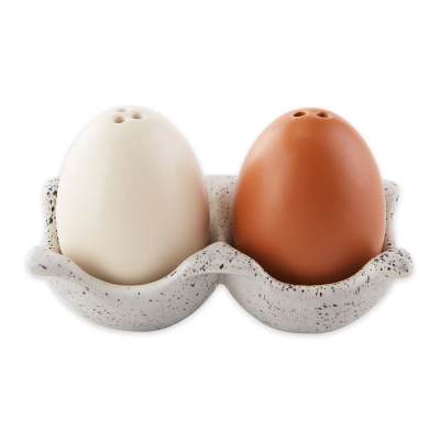Two ceramic egg-shaped shakers in a speckled holder
