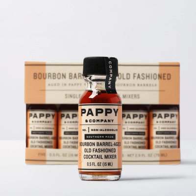 Bottle of non-alcoholic old fashioned cocktail mixer in front of a boxed set