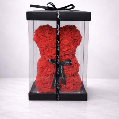 Red rose teddy bear in a clear gift box with a black ribbon
