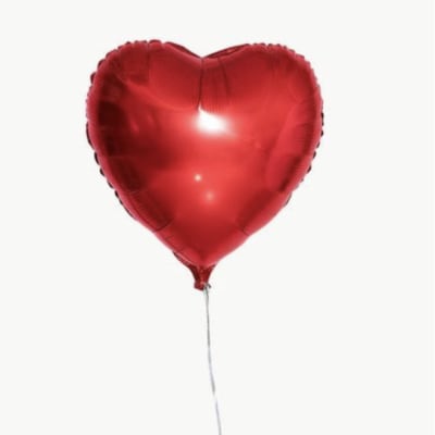 Red heart-shaped balloon with a thin silver string