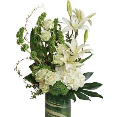 White roses and lilies in a green glass vase