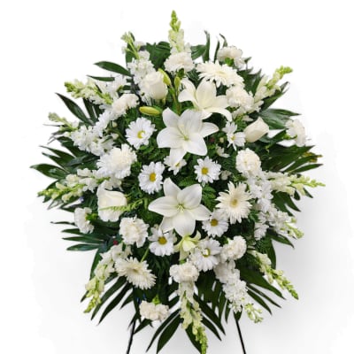 White funeral spray with lilies, daisies, and carnations