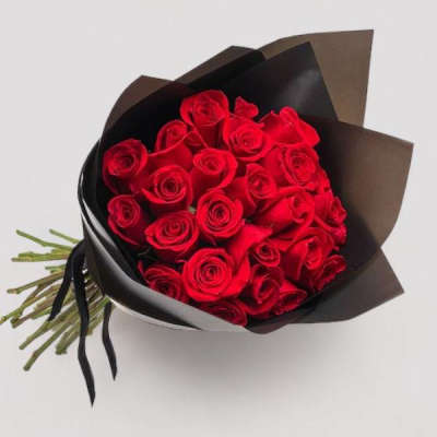 Bouquet of red roses wrapped in black paper