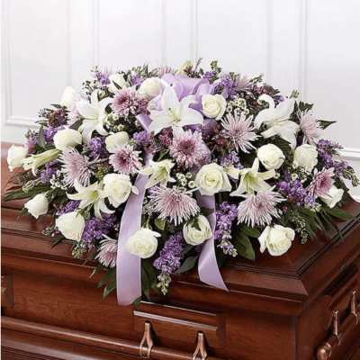 Lavender and white floral casket spray with lilies and roses