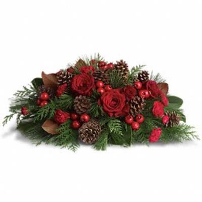 Low red rose and carnation centerpiece with pinecones, red berries, and evergreen branches