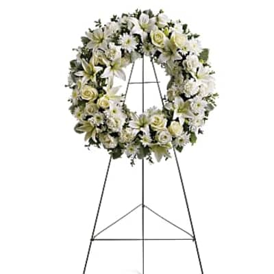 White floral funeral wreath on a standing easel