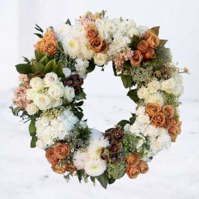 Heart-shaped floral wreath with white and peach roses