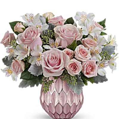 Pink roses and white flowers arranged in a pink vase