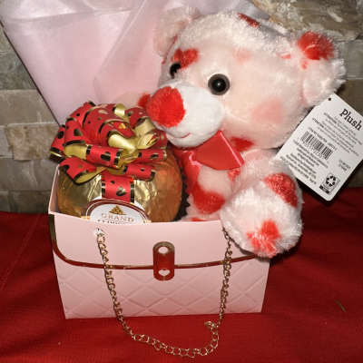 Gift box with a teddy bear and wrapped chocolate gift