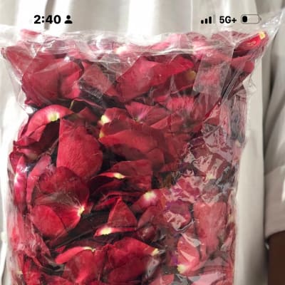 Bag of red rose petals held upright in plastic wrap