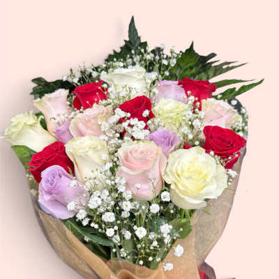 Bouquet of multicolored roses with baby's breath and a red ribbon