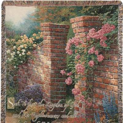 Decorative woven throw with a garden scene of brick walls and pink flowers