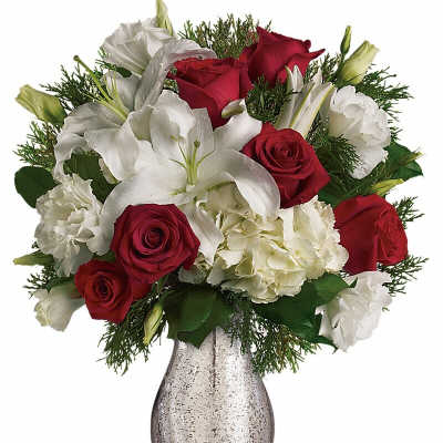 Red roses and white lilies arranged in a silver vase