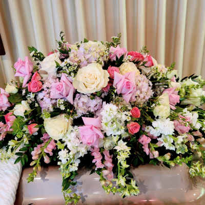 Large pink and white floral arrangement with roses and mixed blooms