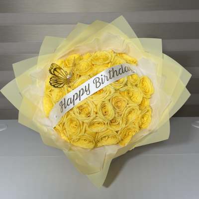 Yellow rose bouquet with a Happy Birthday ribbon and butterfly decoration