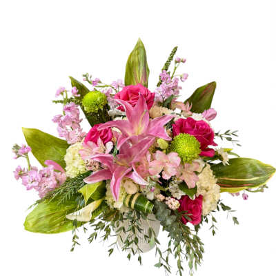 Pink lilies and roses in a white vase with mixed blooms