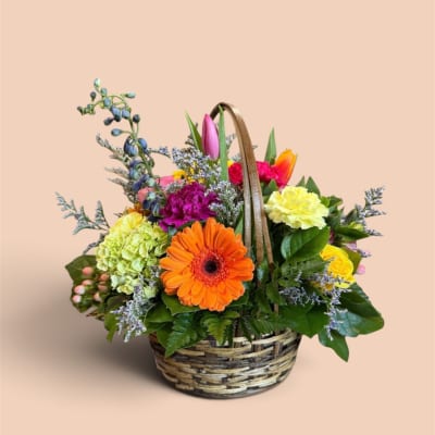 Mixed flower basket with an orange gerbera daisy and colorful blooms