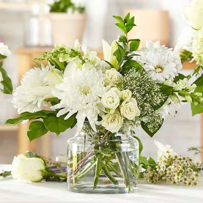 White flowers arranged in a clear glass vase