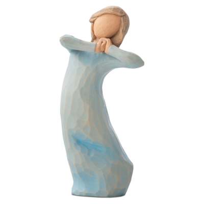 Carved figurine of a person in a blue dress with hands clasped