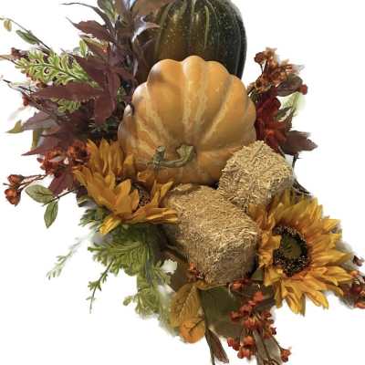 Autumn arrangement with pumpkins, sunflowers, and dried foliage