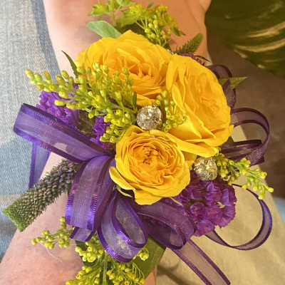 Yellow rose wrist corsage with purple ribbon and small crystal accents