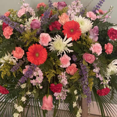 Large mixed floral spray with pink, red, and white blooms