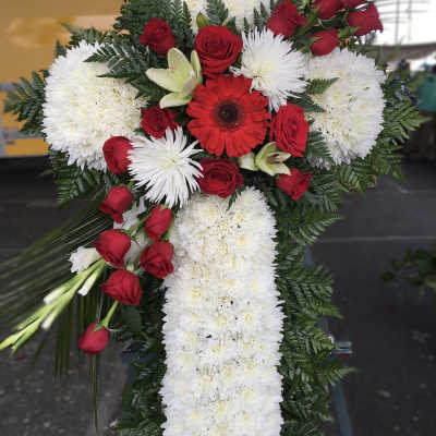 Cross-shaped floral spray with red roses and white chrysanthemums