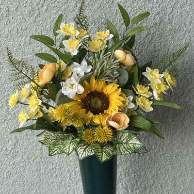 Yellow and white floral arrangement in a tall dark vase