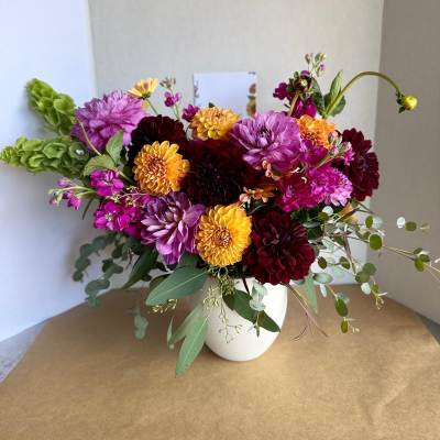 Colorful dahlia bouquet in a white vase