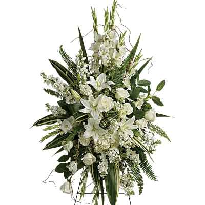 Tall white standing spray of lilies and roses on a metal easel