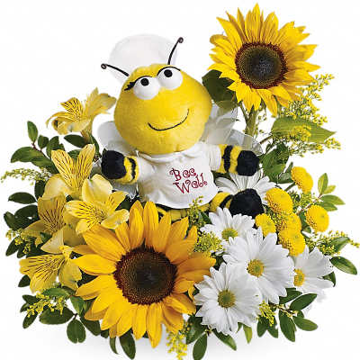 Cheerful bee plush sits among yellow sunflowers, white daisies, and yellow blossoms.